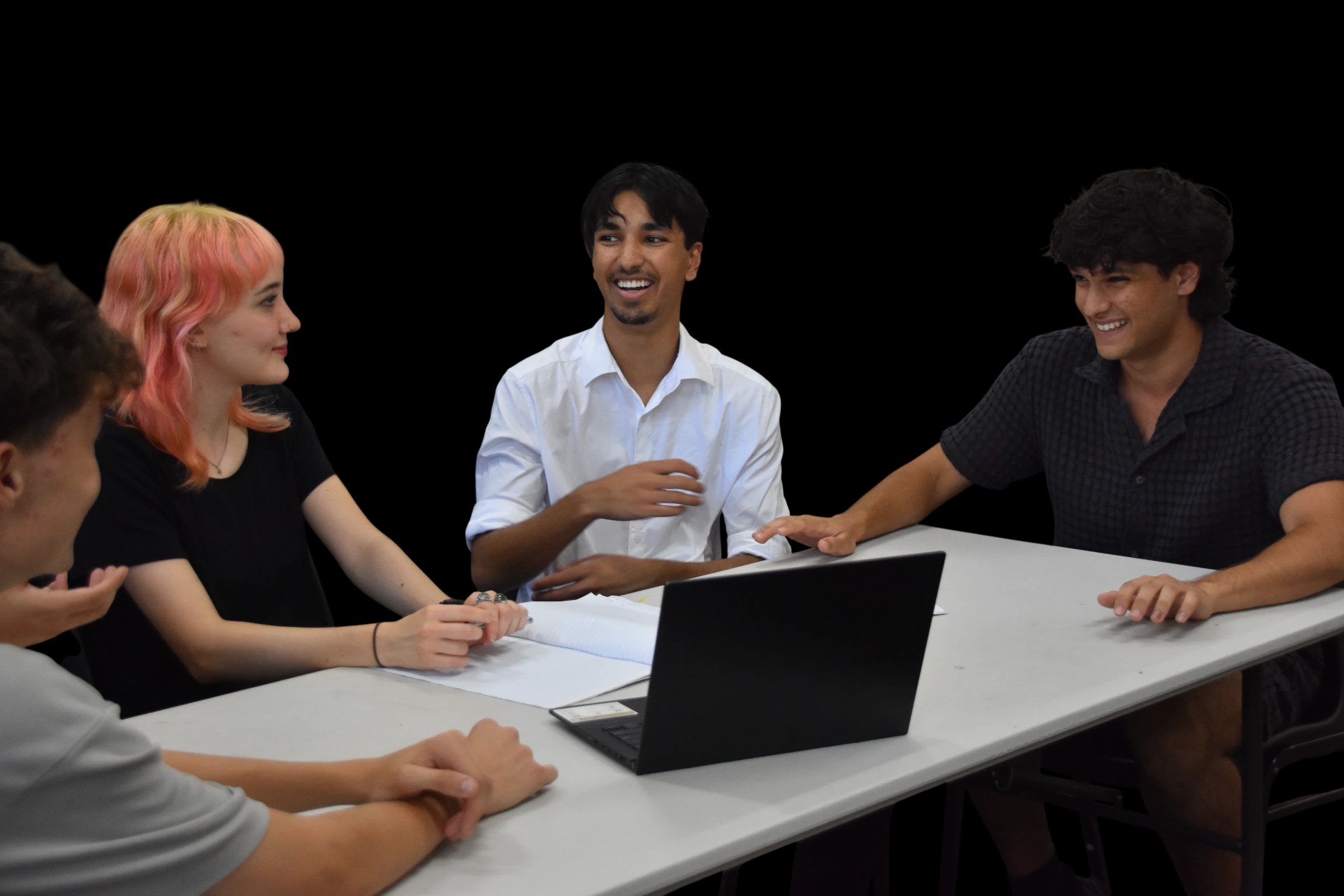 Tutors and students working together around a table
